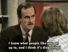 a man in a suit and tie is talking to a woman in a plaid shirt