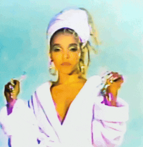 a woman with a towel on her head is holding a bottle