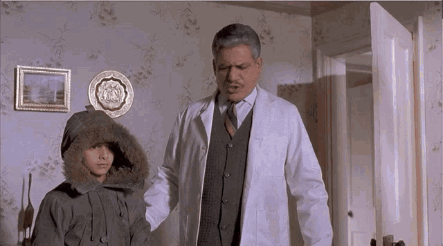 a man in a white coat is standing next to a boy in a fur coat