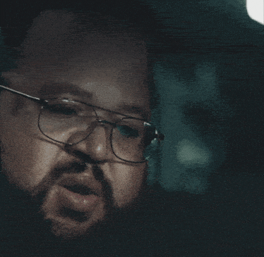 a man wearing glasses says holy fuck on the bottom right