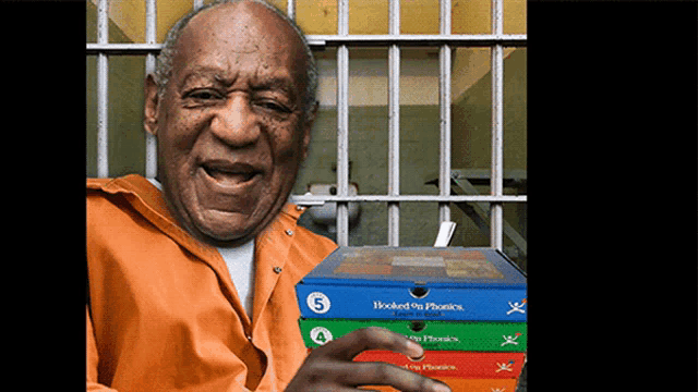 a man in a jail cell holds up a stack of hooked on phonics books