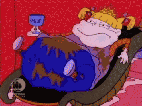 a cartoon character is sitting in a chair holding a cup of syrup .