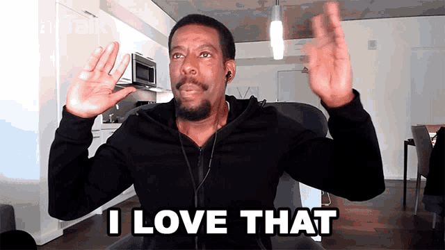 a man wearing headphones says i love that while sitting in a chair