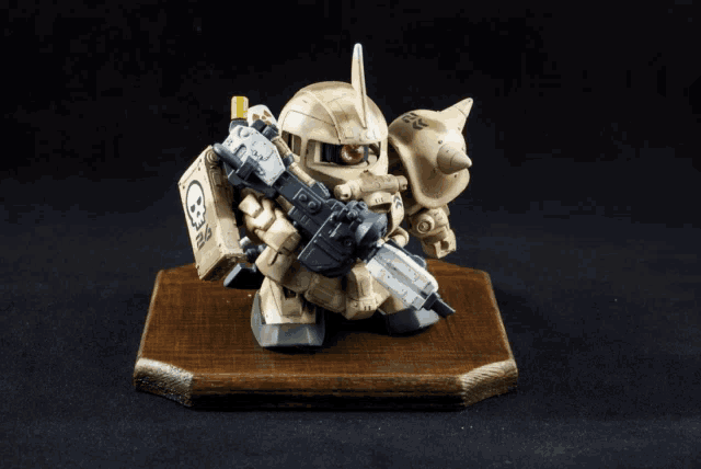 a toy robot with a gun and a red eye