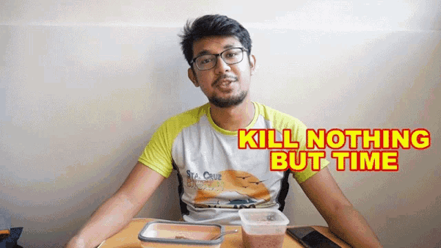 a man sitting at a table with the words kill nothing but time on the screen