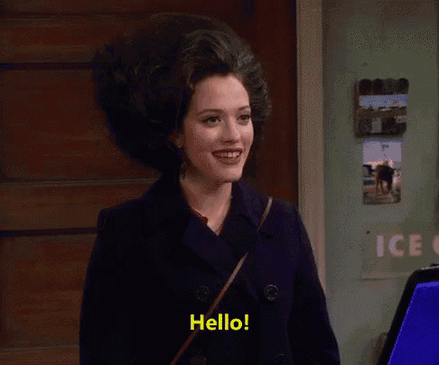 a woman in a black coat says hello in yellow letters