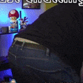 a man in a black shirt and blue jeans is squatting down in a room