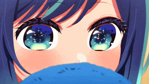a close up of a girl 's eyes with blue and green