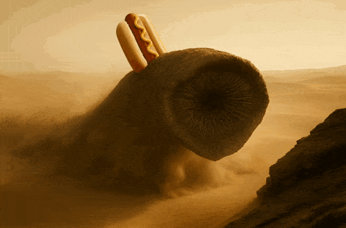 a hot dog with mustard on it is being eaten by a worm