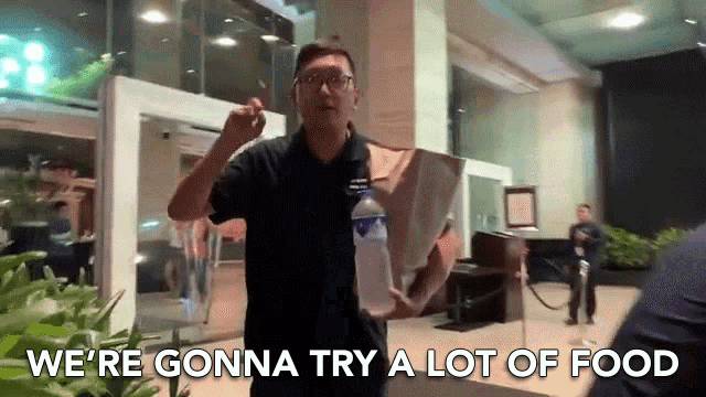 a man holding a bag and a bottle of water says we 're gonna try a lot of food