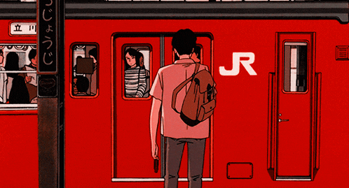 a man with a backpack is standing in front of a red train with chinese writing on it