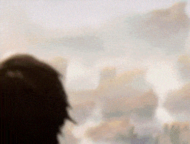 a blurry picture of a person looking out a window at a cloudy sky