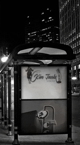 a black and white photo of a bus stop advertising the kim jacoby show