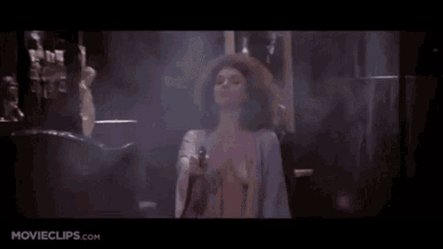 a woman is holding a gun and says fuck me tony