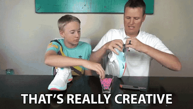 a man and a boy are sitting at a table with the words that 's really creative on the bottom