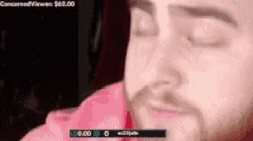 a close up of a man 's face with his eyes closed in front of a screen that says 6:00
