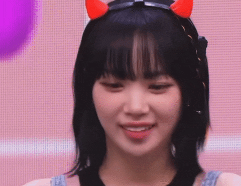 a close up of a woman wearing a headband with horns on it