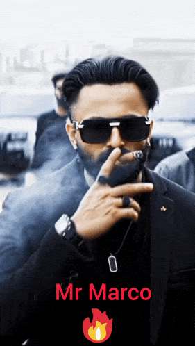 a man in a suit and sunglasses smoking a cigar with the name mr marco on the bottom right