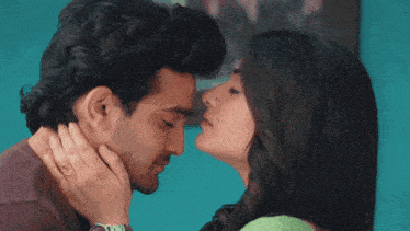 a man and a woman are kissing and the woman is wearing a ring on her finger
