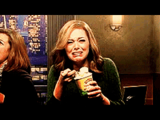 a woman is crying while holding a cup of coffee