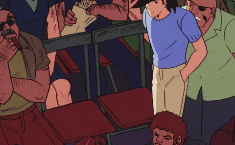 a man in a blue shirt is standing in the middle of a crowd