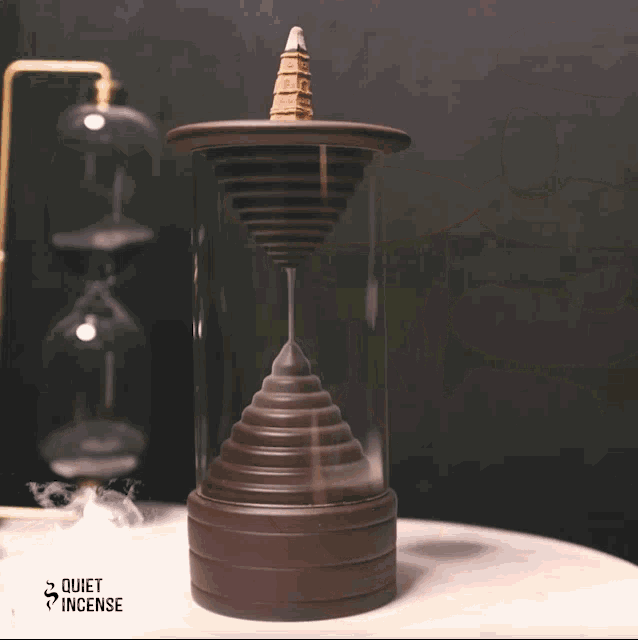 a quiet incense burner with a tower on top of it