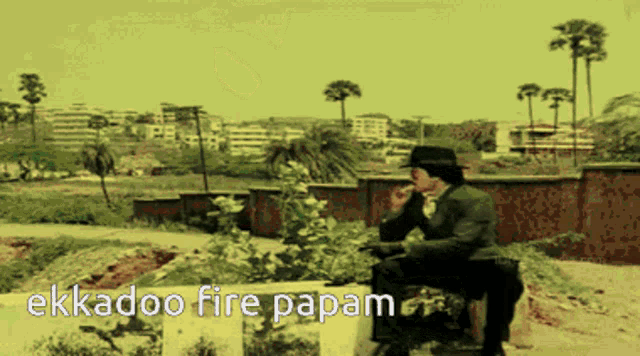 a man sitting on a bench with the words ekkadoo fire papam on the bottom