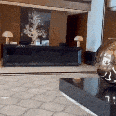 a hotel lobby with a black desk and a globe on a table