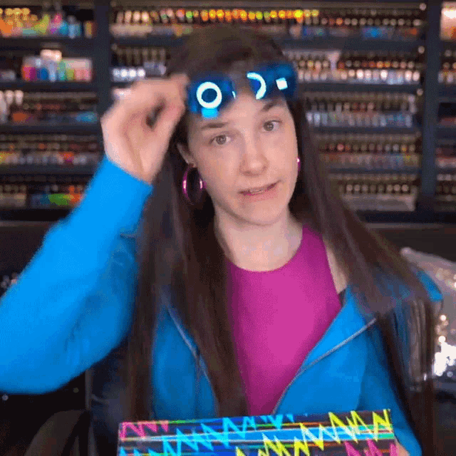a woman in a blue jacket is wearing a pair of sunglasses