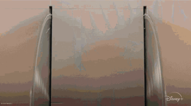 a close up of a person 's hand reaching out towards a glass door .