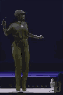 a woman singing into a microphone while dancing on a stage