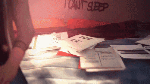 a sign that says " i can 't sleep " is on a bed