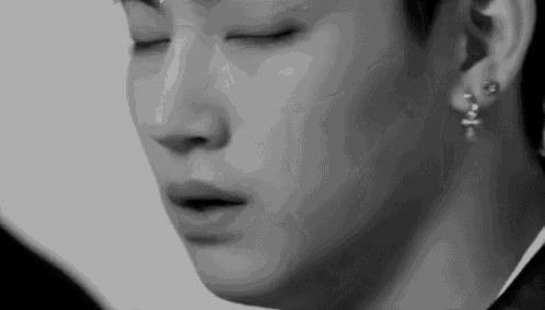 a close up of a man 's face with his eyes closed .