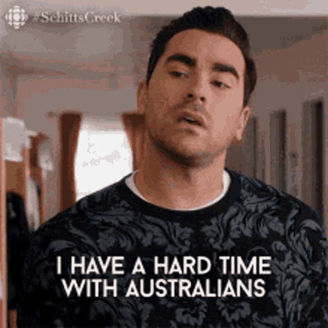 a man is wearing a blue sweater and saying `` i have a hard time with australians '' .