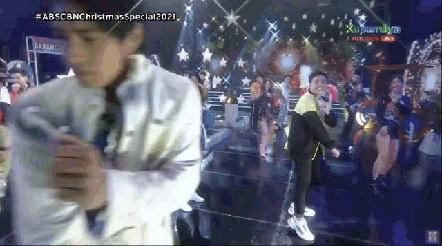 a group of people are dancing on a stage with the words abscbn christmas special 2021 written on the bottom