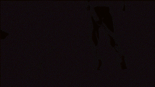 a blurred image of a person 's face with a gray background