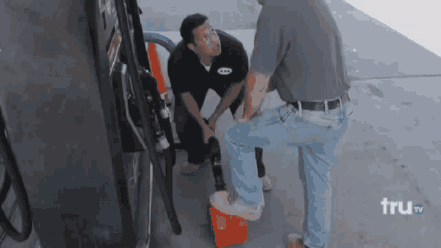two men are working on a gas pump with the words tru tv on the bottom