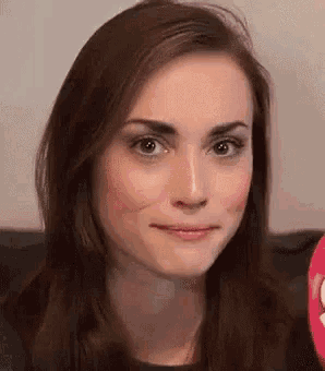a close up of a woman 's face with a smile on her face .