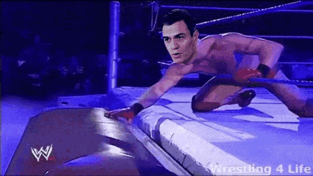 a man is wrestling in a wrestling ring with the words wrestling 4 life below him