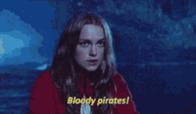 a woman in a red jacket is pointing at something and says bloody pirates !