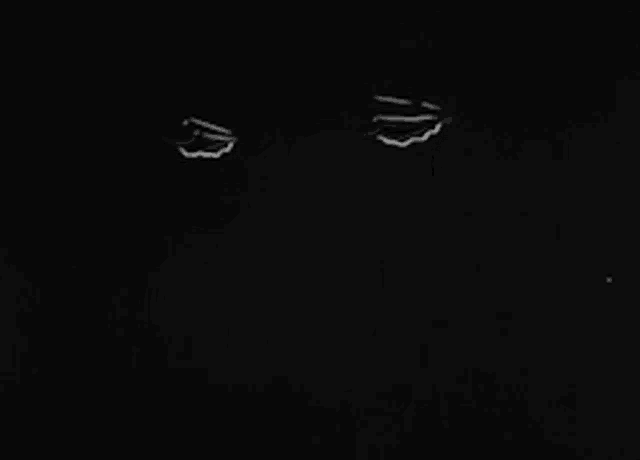 a black and white photo of a person 's face with a few lines on it .