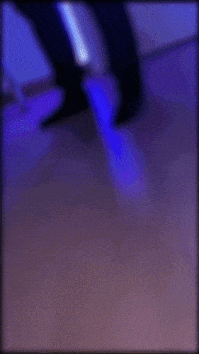 a blurry picture of a person using a computer with a blue background