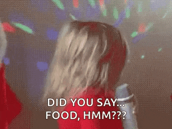a woman is dancing at a party and says `` did you say ... food , hmm ? ''