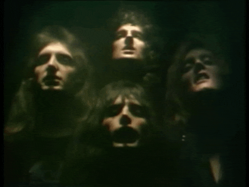 a group of men are standing in a dark room with their heads visible