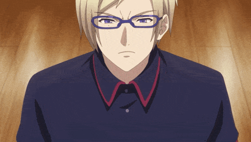 a man wearing glasses and a blue shirt is looking at the camera