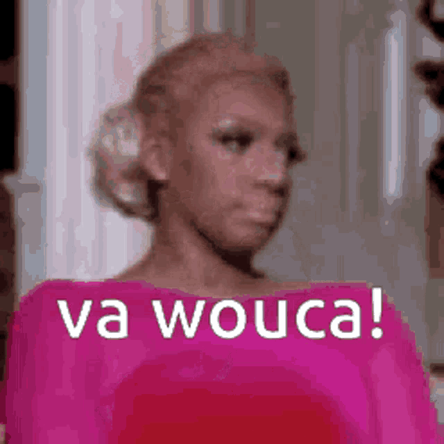 a woman in a pink dress with the words `` va wouca '' written on her face .