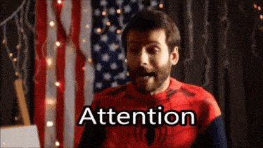 a man in a spiderman costume says " attention "