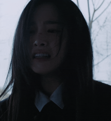 a close up of a woman 's face with dark hair