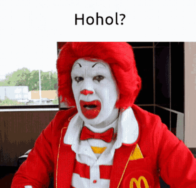 a mcdonald 's clown with a red wig and a white face