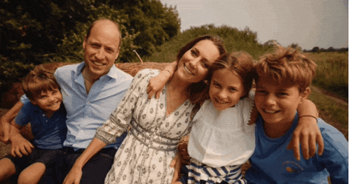a family posing for a picture with a boy wearing a shirt that says ' i love you '